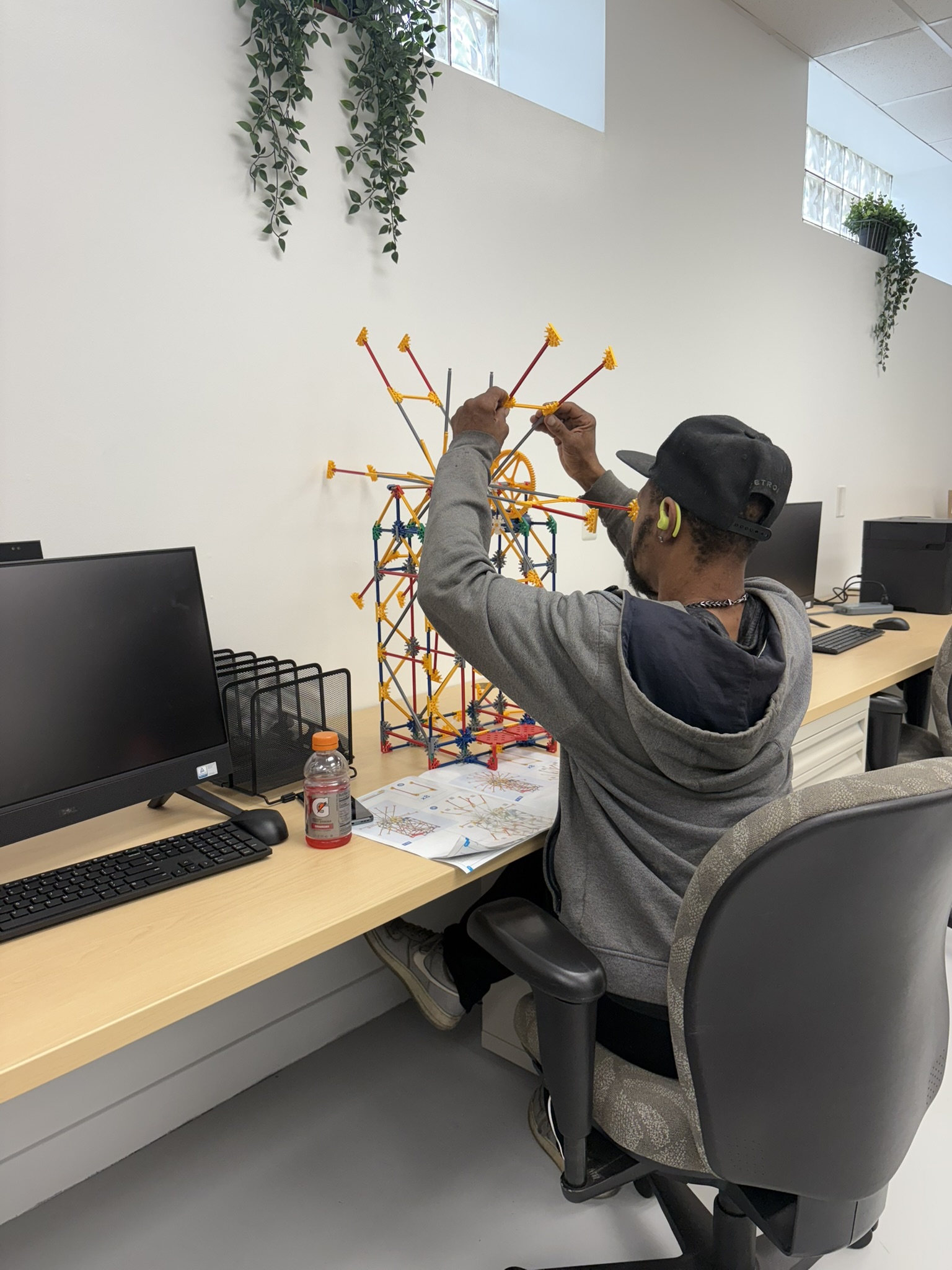 Client working on spatial reasoning by building a K'NEX Ferris Wheel