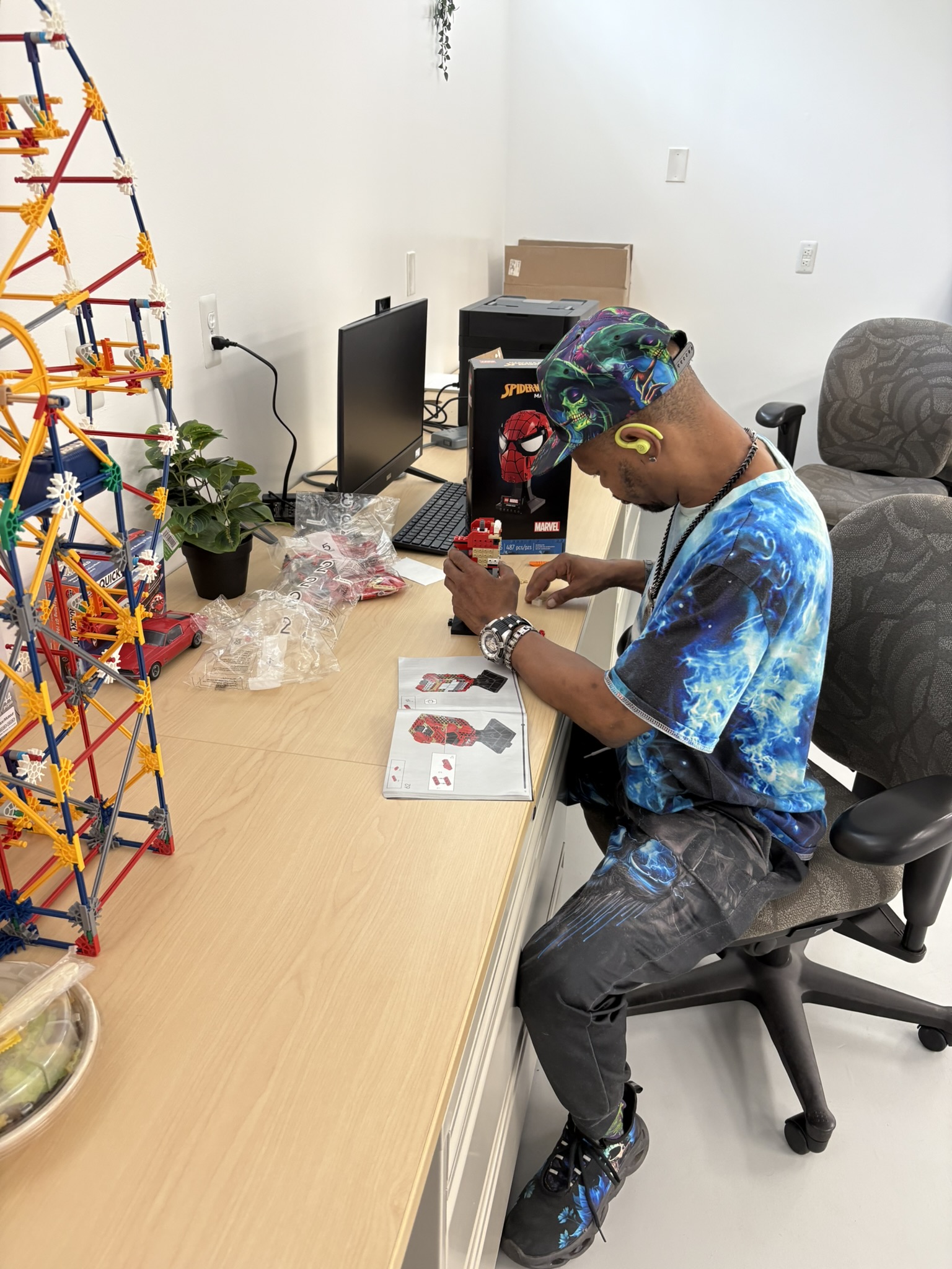 Client demonstrating intense focus while assembling a complex Spider-Man model